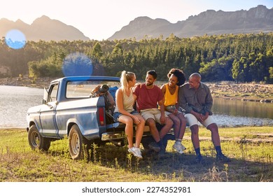 Group Of Friends With Backpacks In Pick Up Truck On Road Trip By Lake And Mountains - Powered by Shutterstock