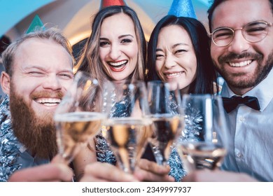 Group of friends in a bar toasting with champagne and celebrating