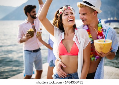Group of friends at beach drinking and having fun. Summer party. - Shutterstock ID 1484358431