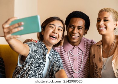 Group of friends bonding at home, LGBTQ and diversity concepts - Homosexual couple and fluid gender non binary young man with cross dressing clothing style having fun in the apartment, LGBT people  - Powered by Shutterstock