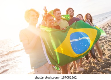 Group Of Friends With Brazilian Flag At Beach