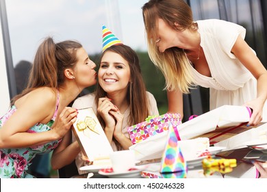 Group Of Friends With Cake And Presents Celebrating Birthday