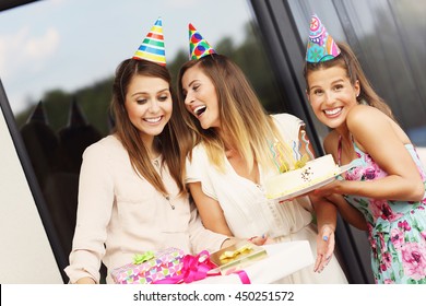 Group Of Friends With Cake And Presents Celebrating Birthday