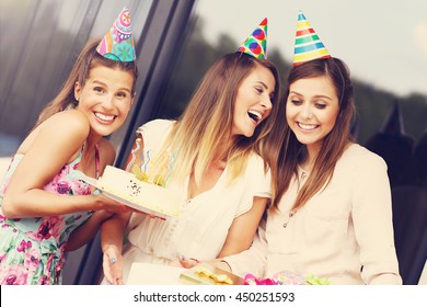 Group Of Friends With Cake And Presents Celebrating Birthday