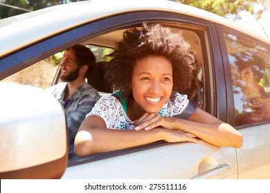 Group Of Friends In Car On Road Trip Together