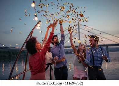 Group Of Friends Celebrating On A Boat Cruise