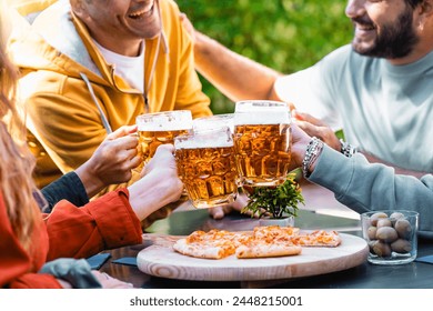 A group of friends cheer with beer mugs over a rustic table laden with pizza, enjoying a convivial feast in an outdoor beer garden. - Powered by Shutterstock