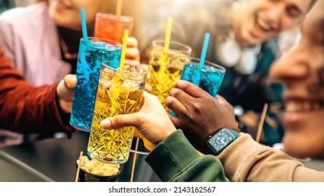 Group of friends cheering drinks glasses together - Young people enjoying happy hour at cocktail open bar - Beverage lifestyle concept - Shutterstock ID 2143162567