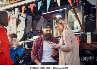 Group Of Friends Chilling Out With Beer In Front Of Food Truck