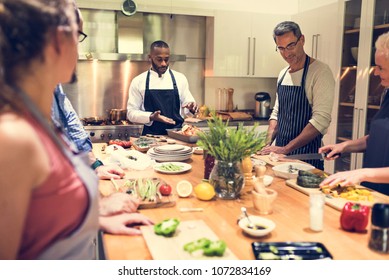 Group of friends are cooking in the kitchen - Shutterstock ID 1072834169