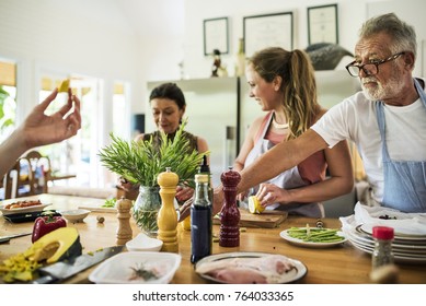 Group Of Friends Are Cooking In The Kitchen