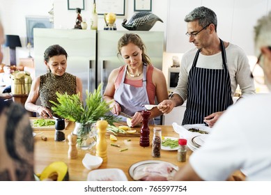 Group Of Friends Are Cooking In The Kitchen