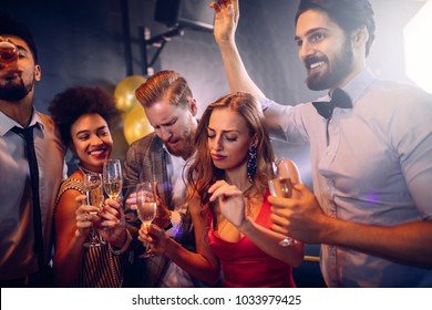 Group of friends dancing at the nightclub - Shutterstock ID 1033979425