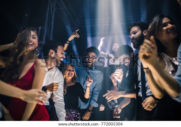 Group of friends\
dancing in the nightclub