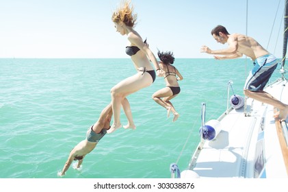 group of friends diving in the water during a boat excursion 