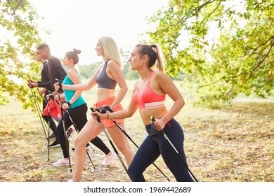 Group Of Friends Doing Nordic Walking In Nature As Fitness And Endurance Training