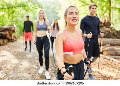 Group Of Friends Doing Nordic Walking For Fitness And Endurance In Nature