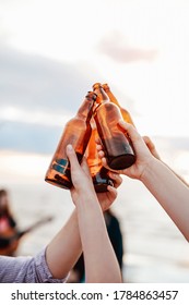 A Group Of Friends, Drinking Beer On The Beach.