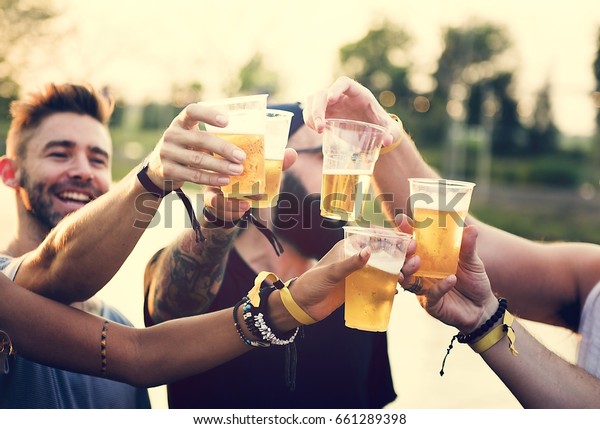 Group of Friends Drinking Beers Enjoying Music\
Festival Together