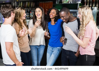 Group Of Friends Drinking Shots In A Nightclub