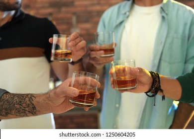 Group Of Friends Drinking Whiskey Together Indoors, Closeup