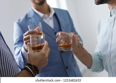 Group Of Friends Drinking Whiskey Together Indoors, Closeup