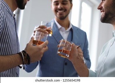 Group Of Friends Drinking Whiskey Together Indoors