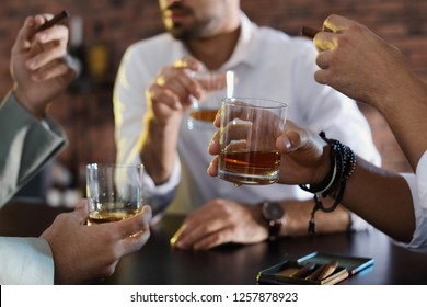 Group Of Friends Drinking Whiskey Together In Bar, Closeup