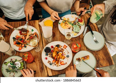 Group of friends eating breakfast or brunch in restaurant - Powered by Shutterstock