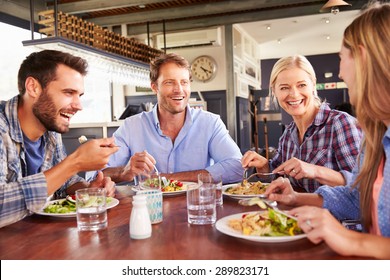 A Group Of Friends Eating At A Restaurant