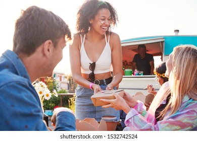 Group Of Friends Eating Takeaway Food From Truck At  Outdoor Music Festival - Powered by Shutterstock