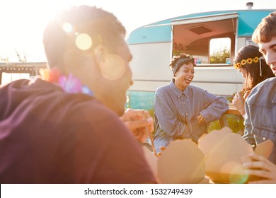 Group Of Friends Eating Takeaway Food From Truck At  Outdoor Music Festival - Powered by Shutterstock