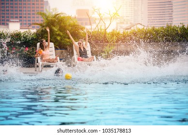 Group Of Friends Enjoy Pool Party And Jumping Into The Swiming Pool Together In Summertime - Vacation , Holiday And Lifestyle Concept