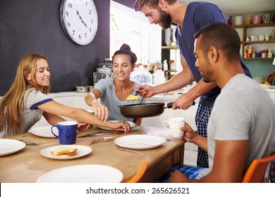 Group Of Friends Enjoying Breakfast In Kitchen Together - Powered by Shutterstock