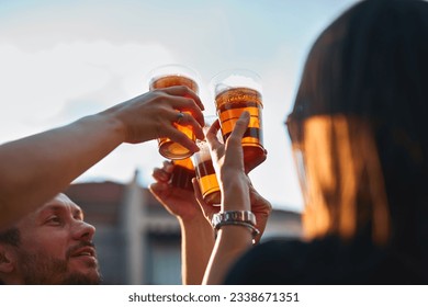 Group of friends enjoying cold beer at a backyard party. - Powered by Shutterstock