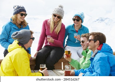 Group Of Friends Enjoying Drink In Bar At Ski Resort