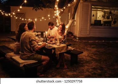 Group Of Friends Enjoying Food And Drinks Together Outside