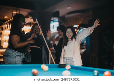 A group of friends enjoying a fun-filled evening playing billiards in a cozy bar setting, sharing laughs and good times together. - Powered by Shutterstock