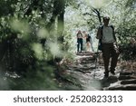 Group of friends enjoying a hike through a scenic forest trail. Perfect for travel, adventure, and outdoor enthusiasts.