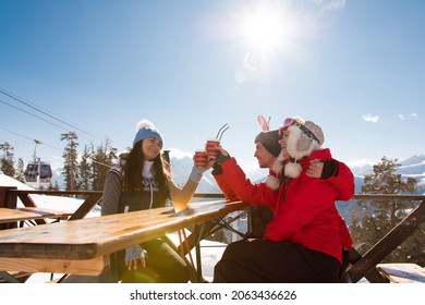 Group Of Friends Enjoying Hot Mulled Wine In Cafe At Ski Resort. - Powered by Shutterstock