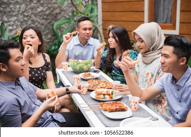 Group of friends enjoying lunch at outdoor garden - Powered by Shutterstock