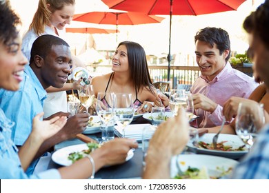 Group Of Friends Enjoying Meal At Outdoor Restaurant - Powered by Shutterstock