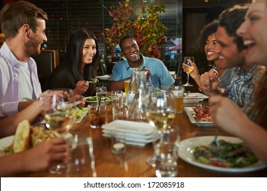 Group Of Friends Enjoying Meal In Restaurant