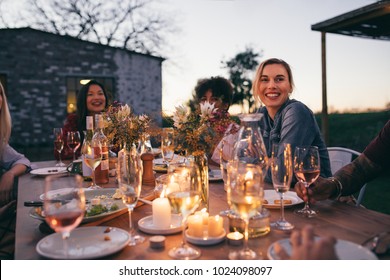 Group Of Friends Enjoying Outdoor Party In Garden Restaurant . Millennials Enjoying Dinner Outdoors