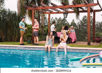 Group of friends enjoying a pool party. Friends at pool barbecue. Summer and outdoor concept. - Powered by Shutterstock