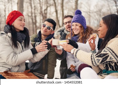 Group of friends enjoying in the snow in winter - Powered by Shutterstock