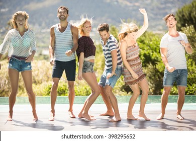 Group Of Friends Enjoying While Dancing At Poolside