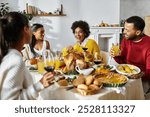 A group of friends enjoys Thanksgiving dinner together, sharing smiles and tasty dishes.