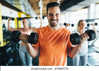 Group of friends exercising together in gym - Powered by Shutterstock