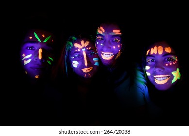group of friends with faces painted at a party